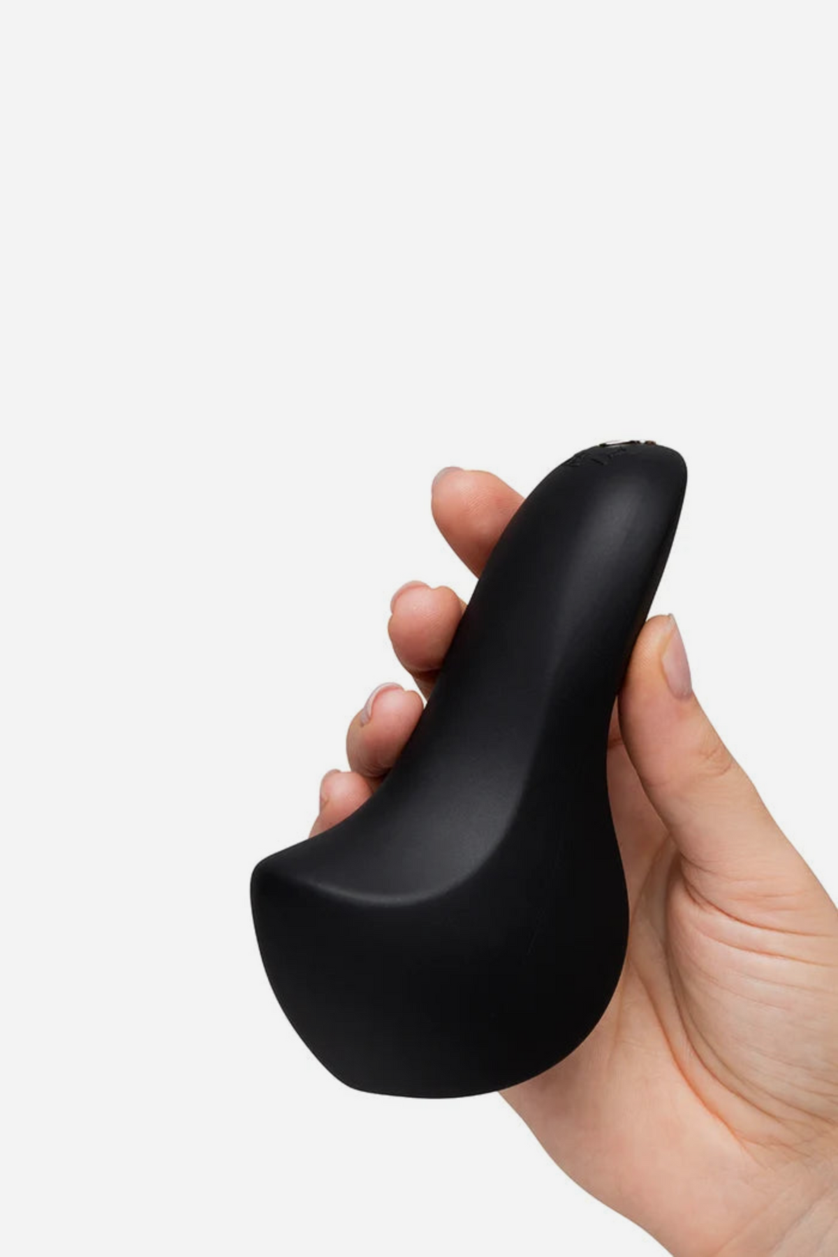 Black We-Vibe Shared Touch couple's vibe held in the hand from the side, showing its smooth matte top that curves to a flared base