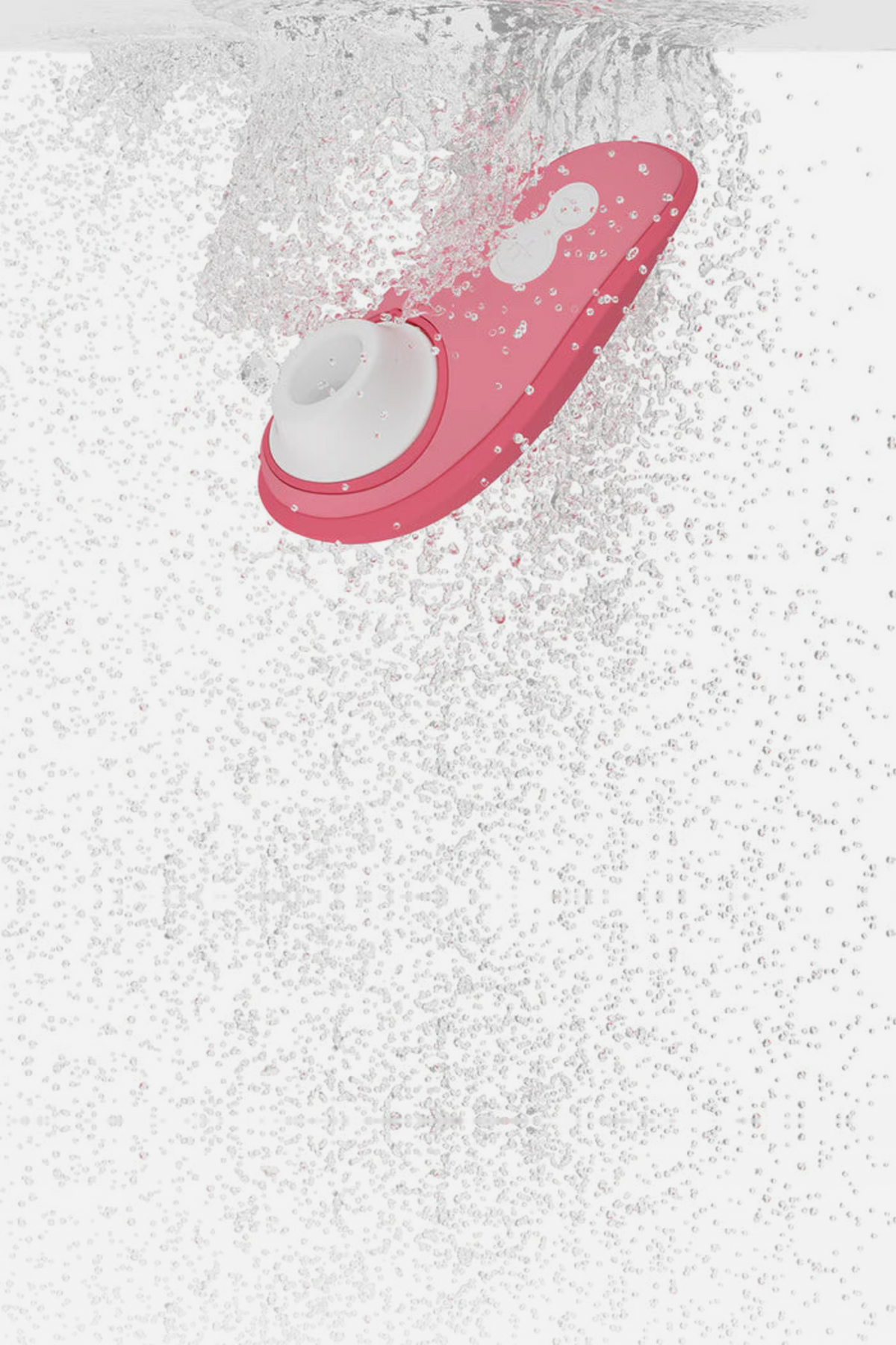 Vibrant rose Womanizer Liberty 2 plunging into water surrounded by bubbles, showing the air pulse toy is fully waterproof for bath or shower