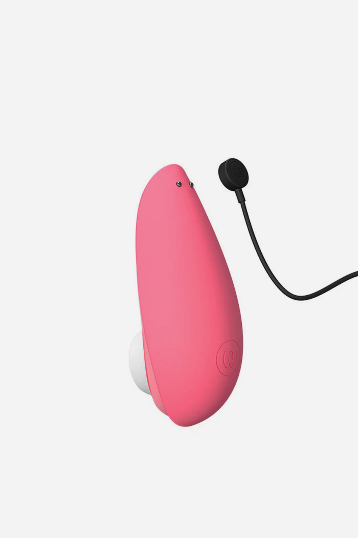 Closed vibrant rose Womanizer Liberty 2 with its black magnetic USB charging cable attached, showing the rechargeable compact design