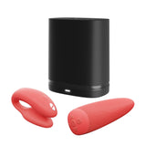 c-shaped hands-free wearable vibrator in coral with matching remote and black storage case