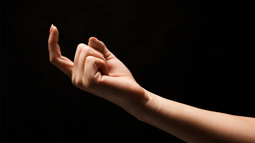 Beckoning finger against black background