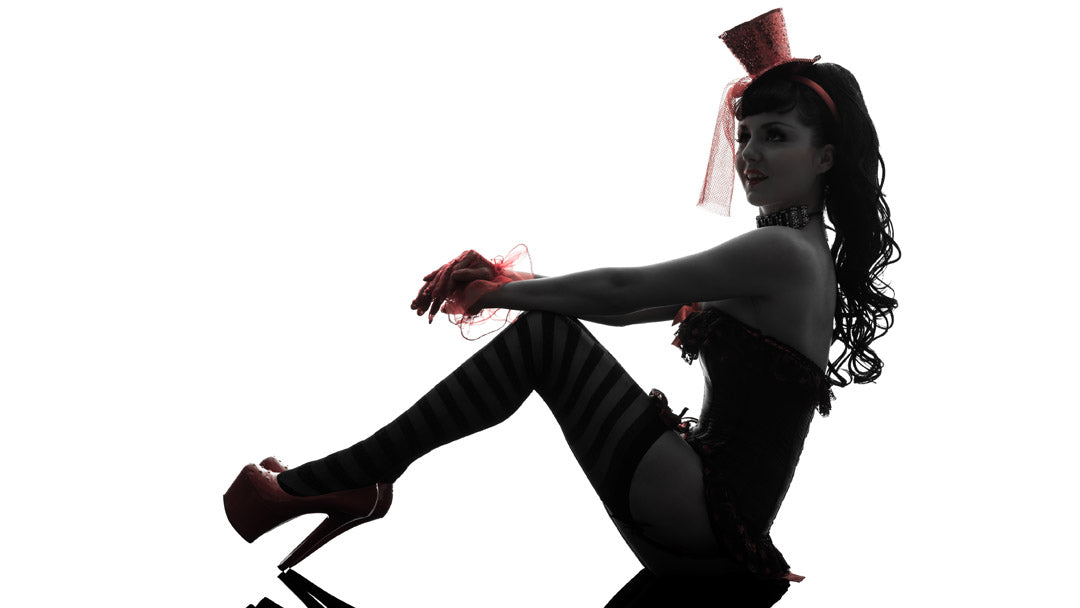 Woman in sexy costume sitting in silhouette