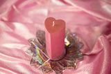 pink heart shaped wax play candle on pink fabric