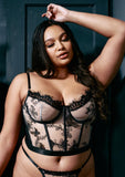 light skinned plus size model in size xxl butterfly bustier poses with eyes closed 