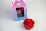 red rose shaped wax play candle next to its pink and blue box