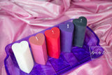 5 colors of wax play candles in heart shaped pillars. colors are white, pink, red, purple, and black