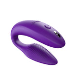 c-shaped hands-free wearable vibrator in purple with textured internal arm and magnetic charging port on top