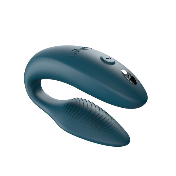 c-shaped hands-free wearable vibrator in dark tealish green color with textured internal arm and magnetic charging port on top