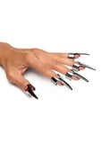 white hand wearing pointed, steel finger claws for kinky sensation play