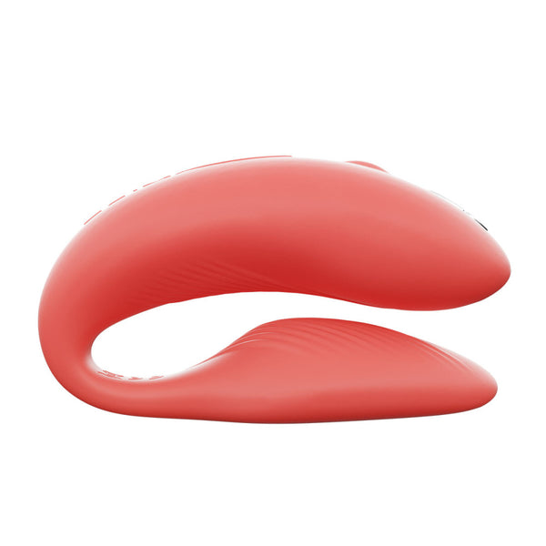 c-shaped wearable hands free couples sex toy with larger top end, which holds the powerful motor that stimulates the clit. the internal bulb underneath is slimmer and slightly textures to stay in place