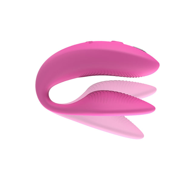pink we-vibe sync 2 with shadows above and below the insertable end. meant to show that the toy is adjustable on the bottom, insertable arm