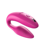c-shaped hands-free wearable vibrator in pink with textured internal arm and magnetic charging port on top