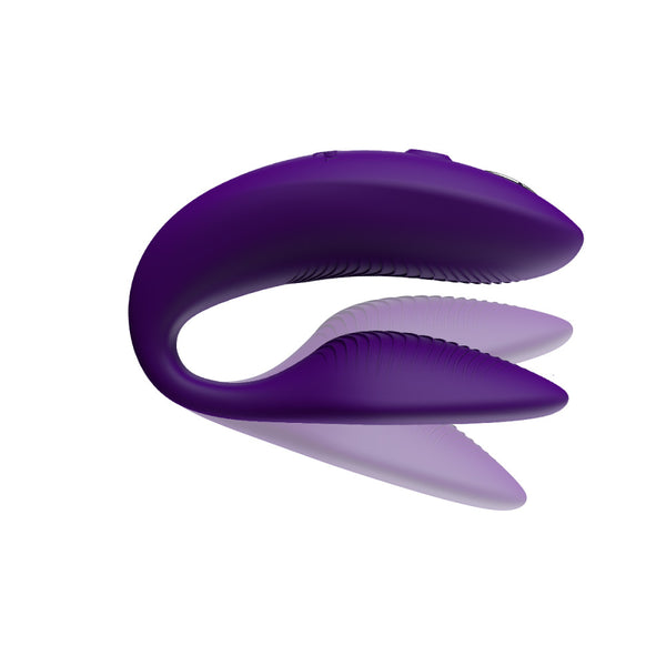 purple we-vibe sync 2 with shadows above and below the insertable end. meant to show that the toy is adjustable on the bottom, insertable arm