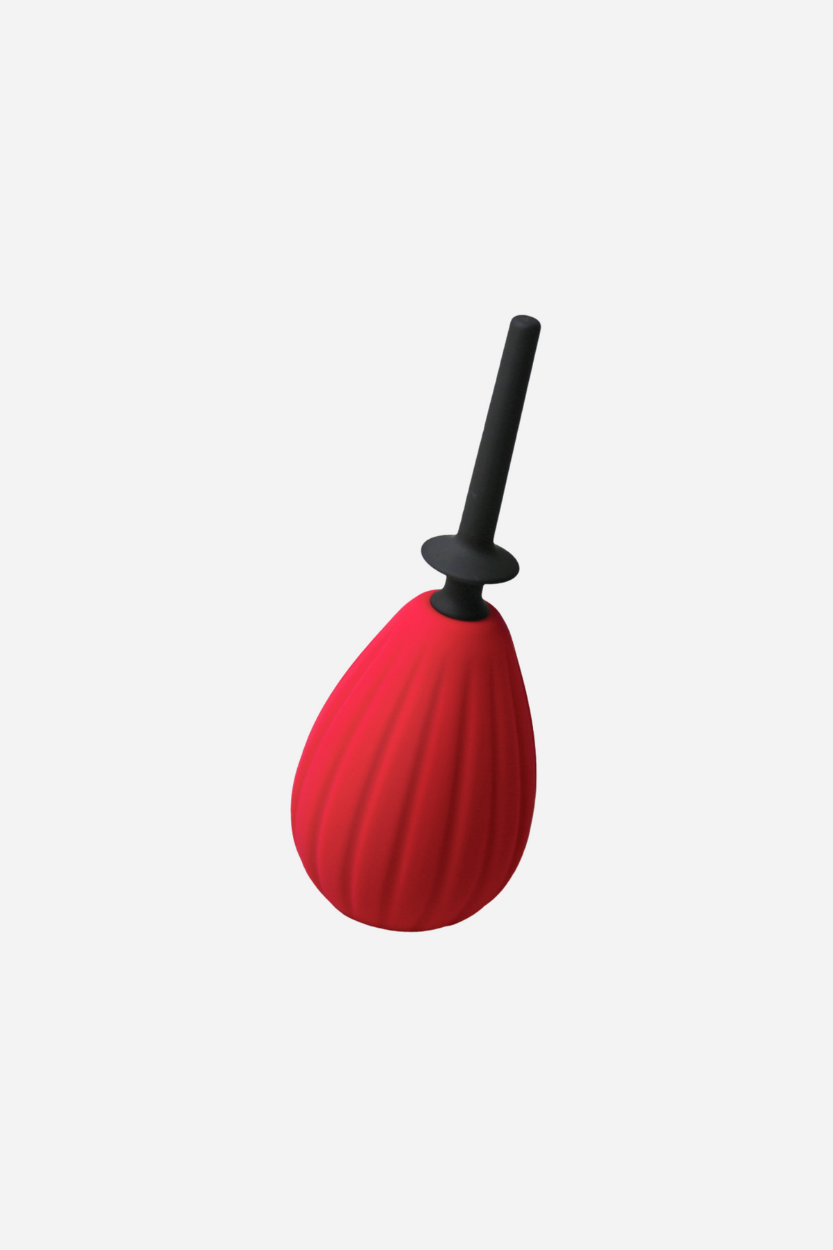 Red ribbed Aneros Prelude silicone enema bulb on grey, standing upright with its slim black nozzle fitted into the top of the bulb.