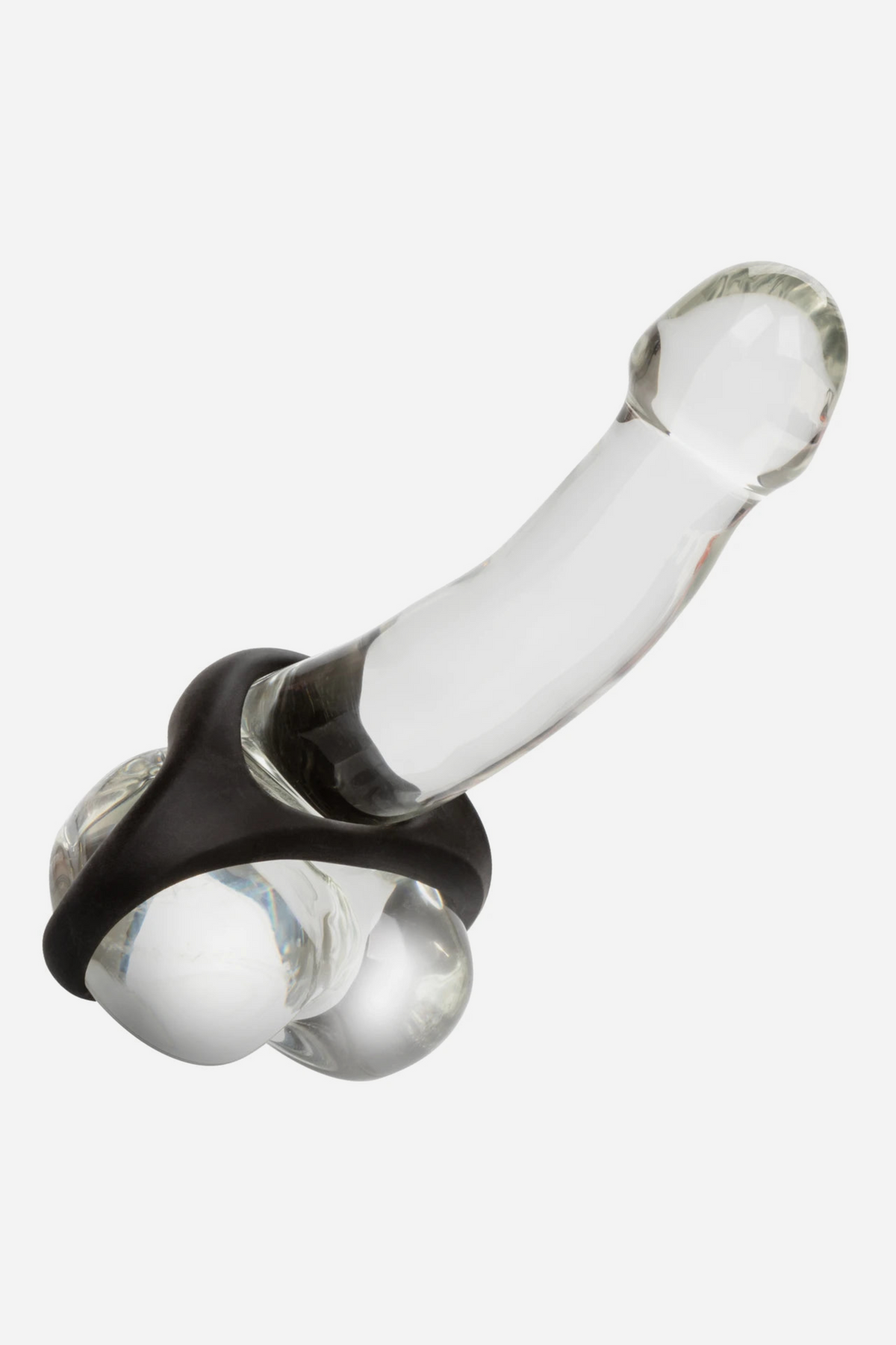 At Your Peak dual enhancer ring fitted around a clear glass dildo, showing how the stretchy silicone ring sits at the base, on grey