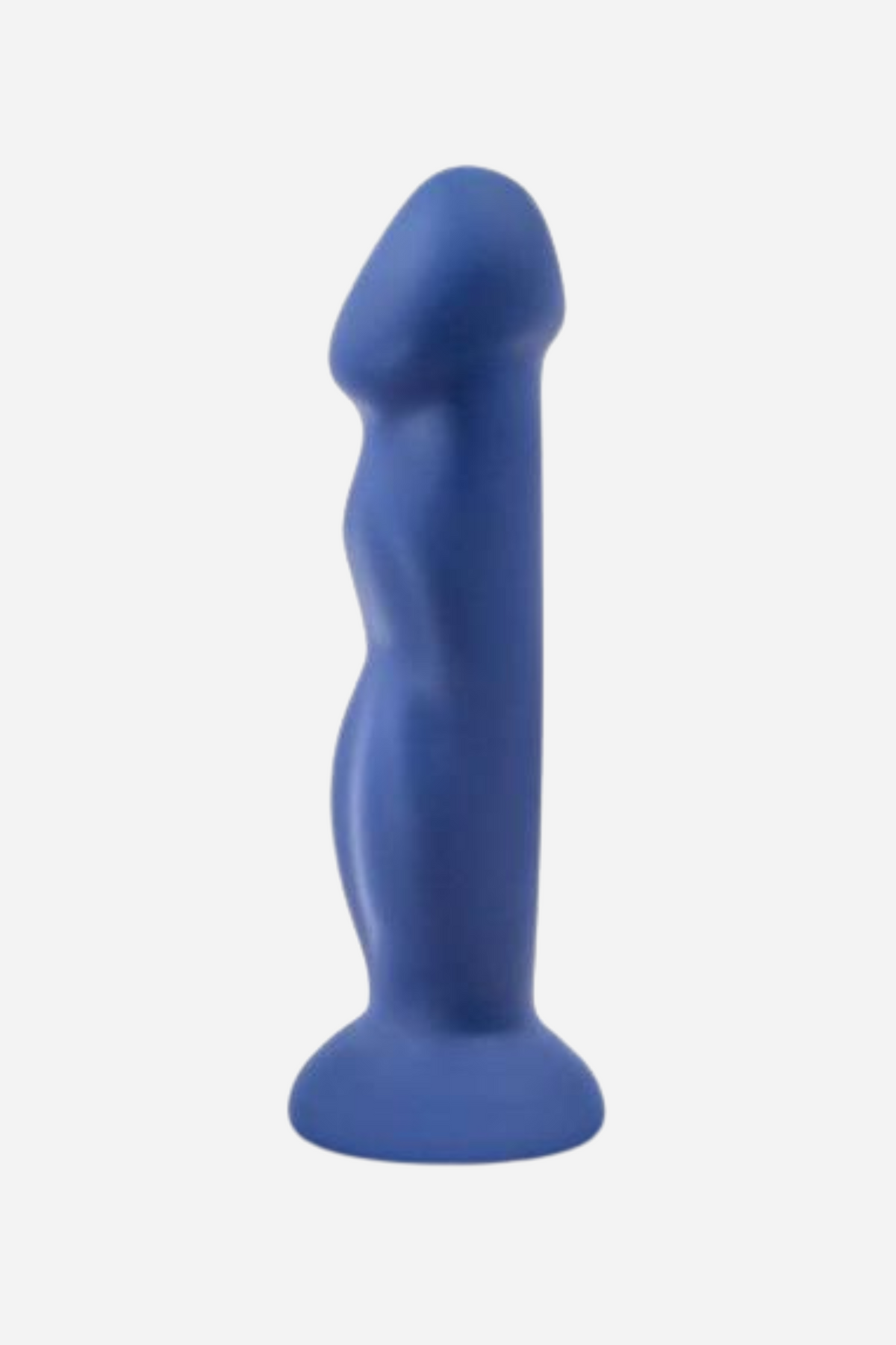An indigo blue silicone dildo standing upright on its round suction base, with a sculpted shaft and rounded head, against a plain grey backdrop.