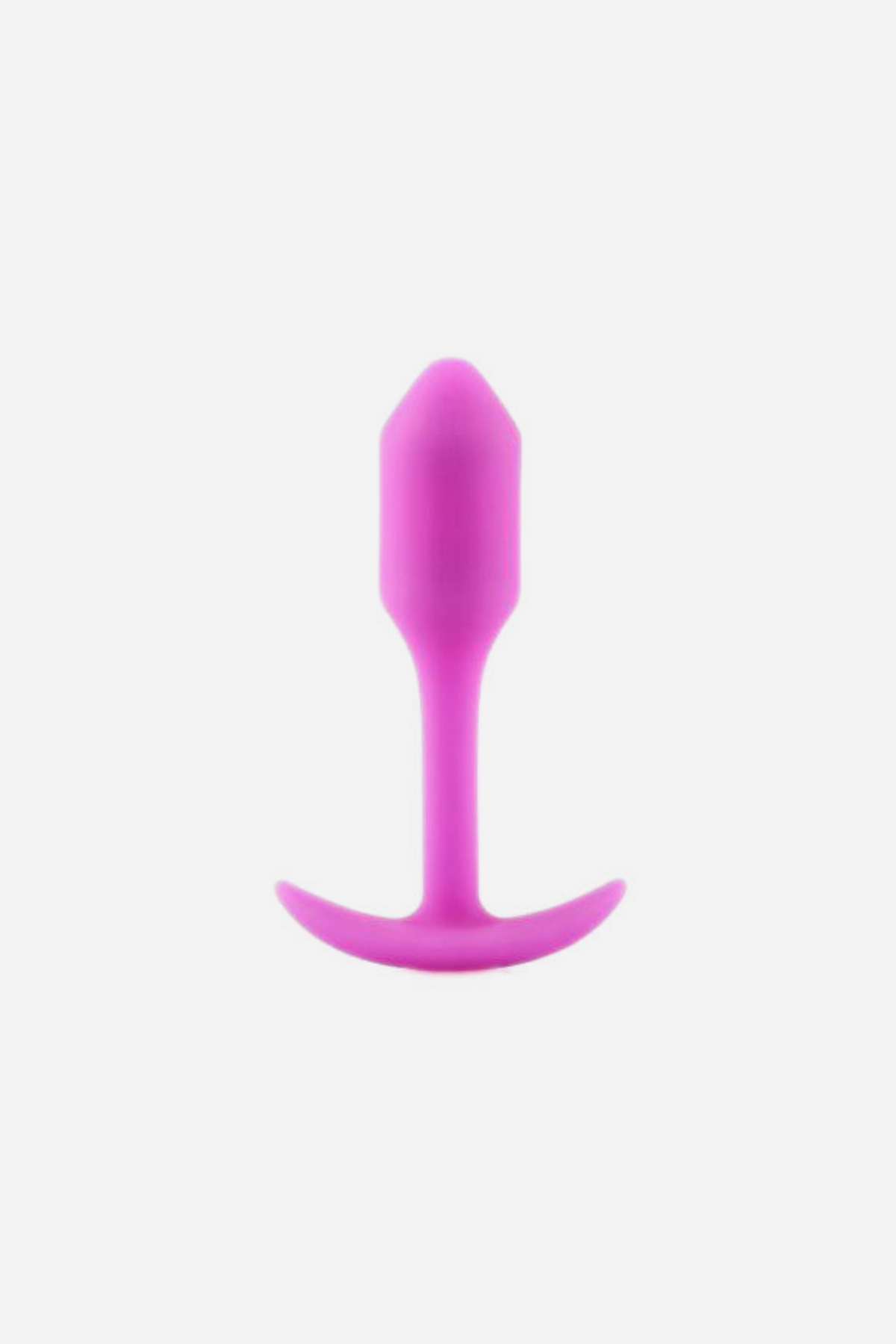 Pink B-Vibe Snug Plug 1 small weighted butt plug standing upright on its flared base, showing the smooth silicone body and slim neck