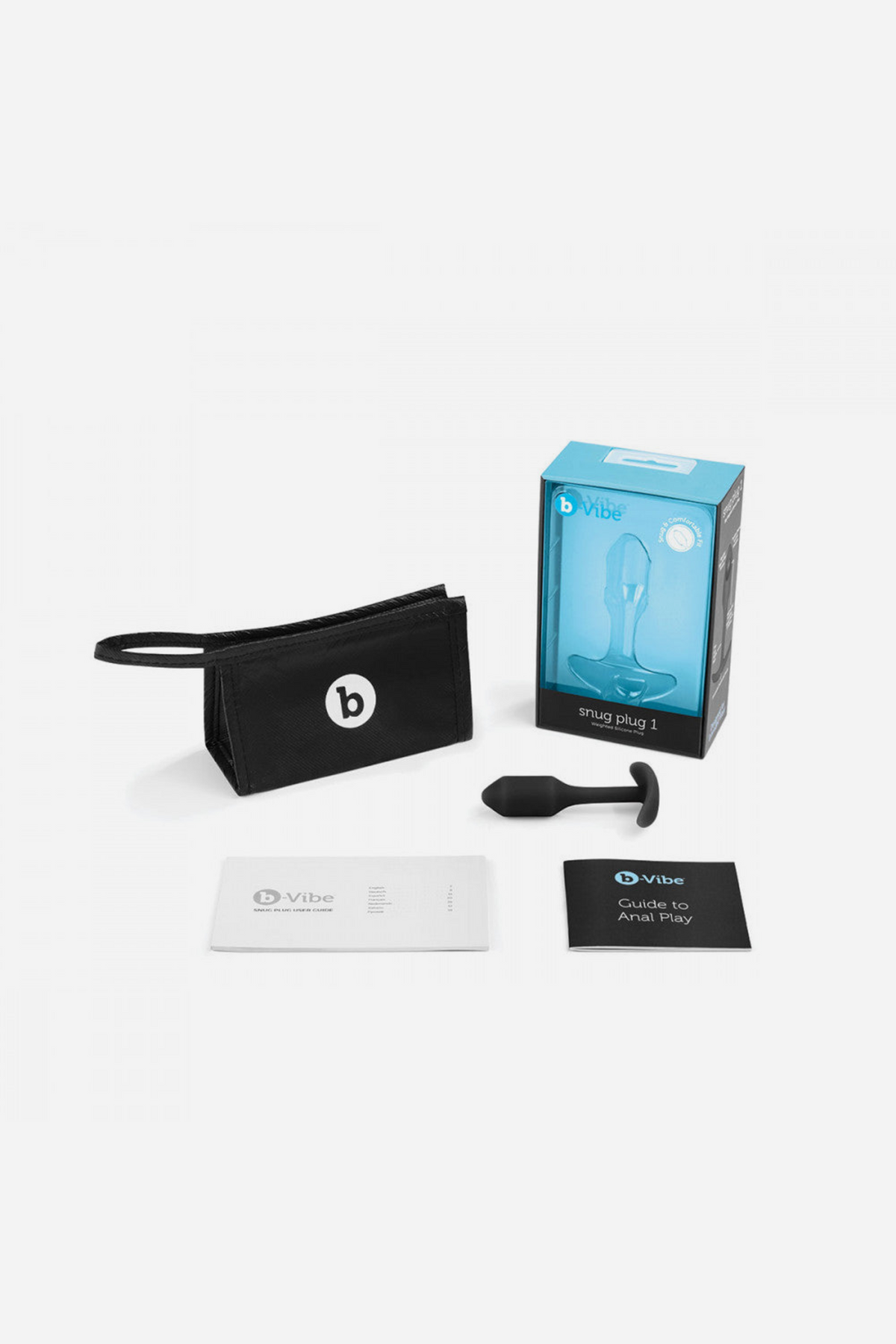 B-Vibe Snug Plug 1 retail box shown with its contents laid out beside it, including the small weighted butt plug and accessories