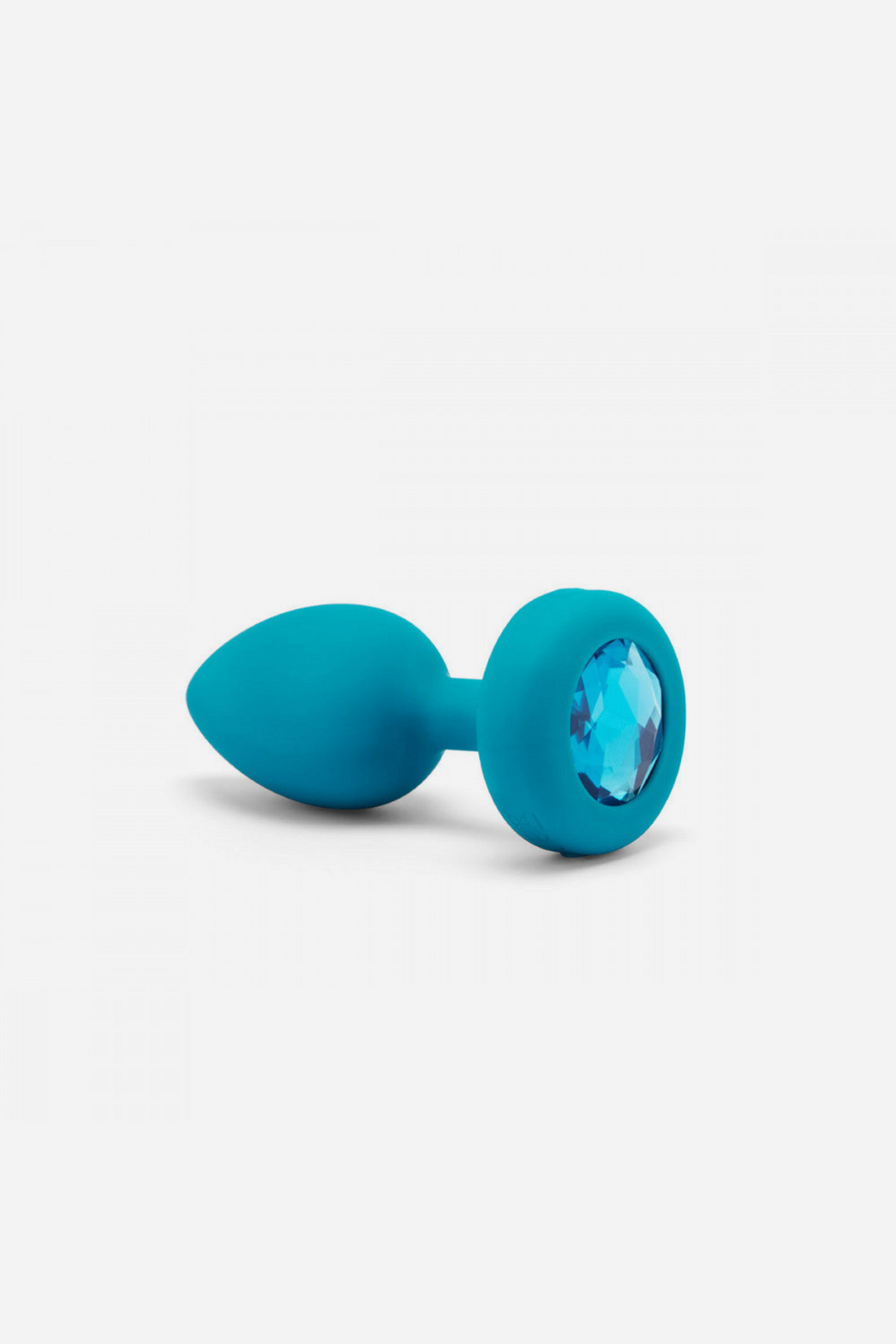 B-Vibe Vibrating Jewel Plug in aqua with a sparkling blue gem base, a rechargeable vibrating silicone butt plug for solo or couples play