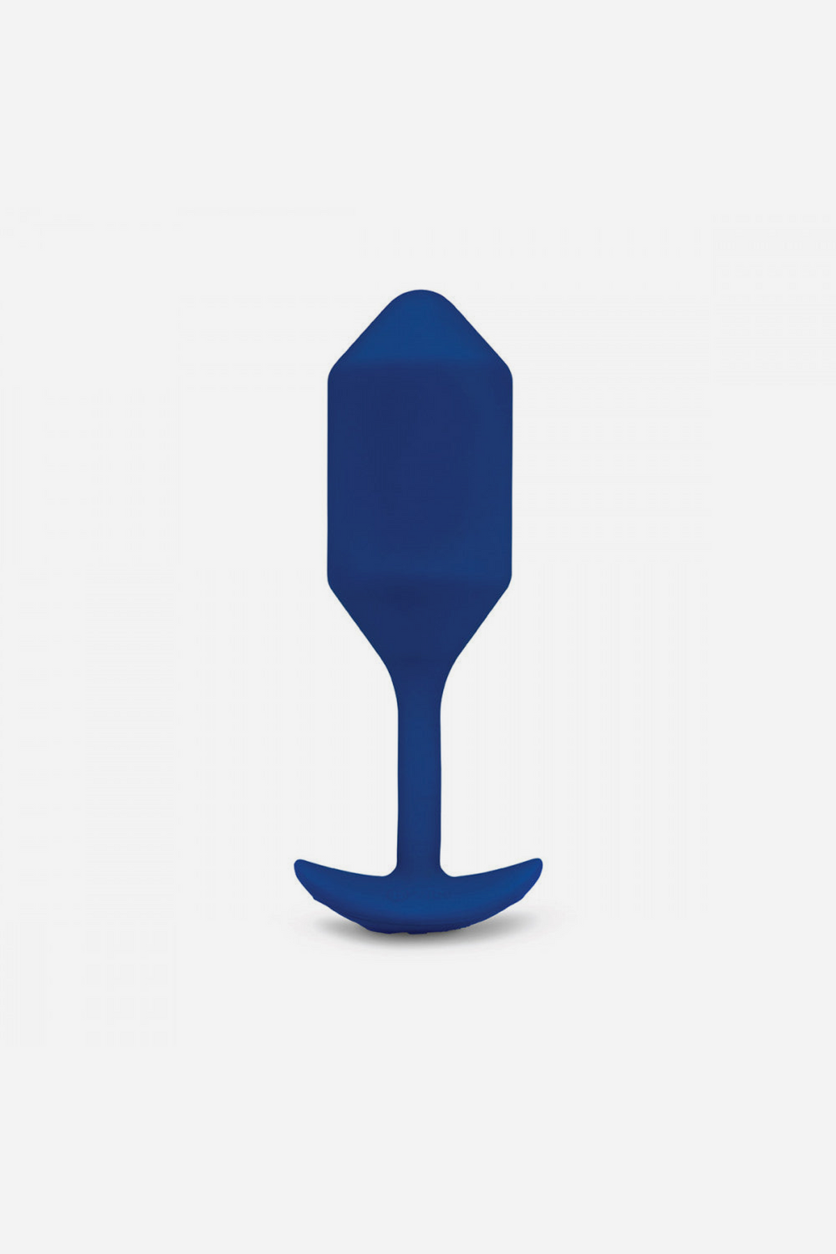 B-Vibe Vibrating Snug Plug 4 large in Navy standing upright, showing the rounded bulb, narrow neck and T-shaped base on grey