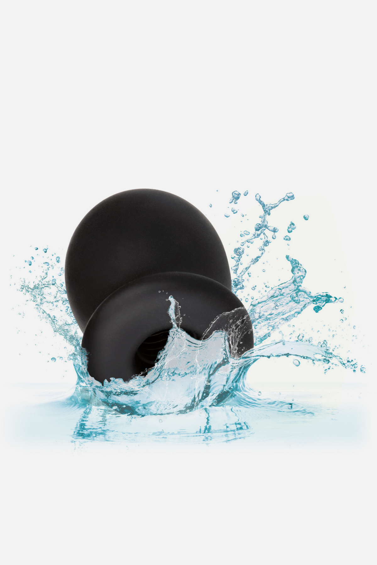 Boundless Buzzing Pleasure FTM vibrating silicone stroker in black being splashed with water, showing it is waterproof, on light grey