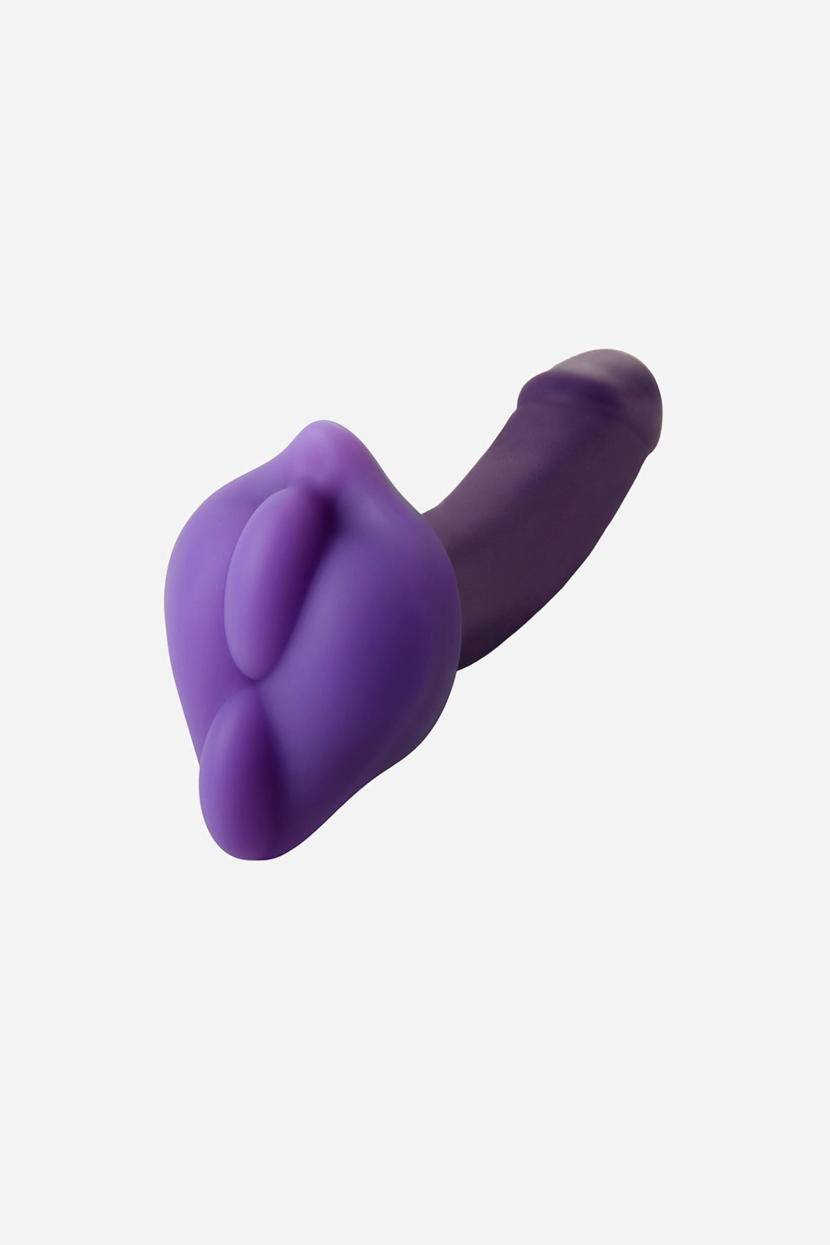 The purple BumpHer pad fitted over the base of a purple dildo, cushioning the shaft where it would meet the harness during wear.