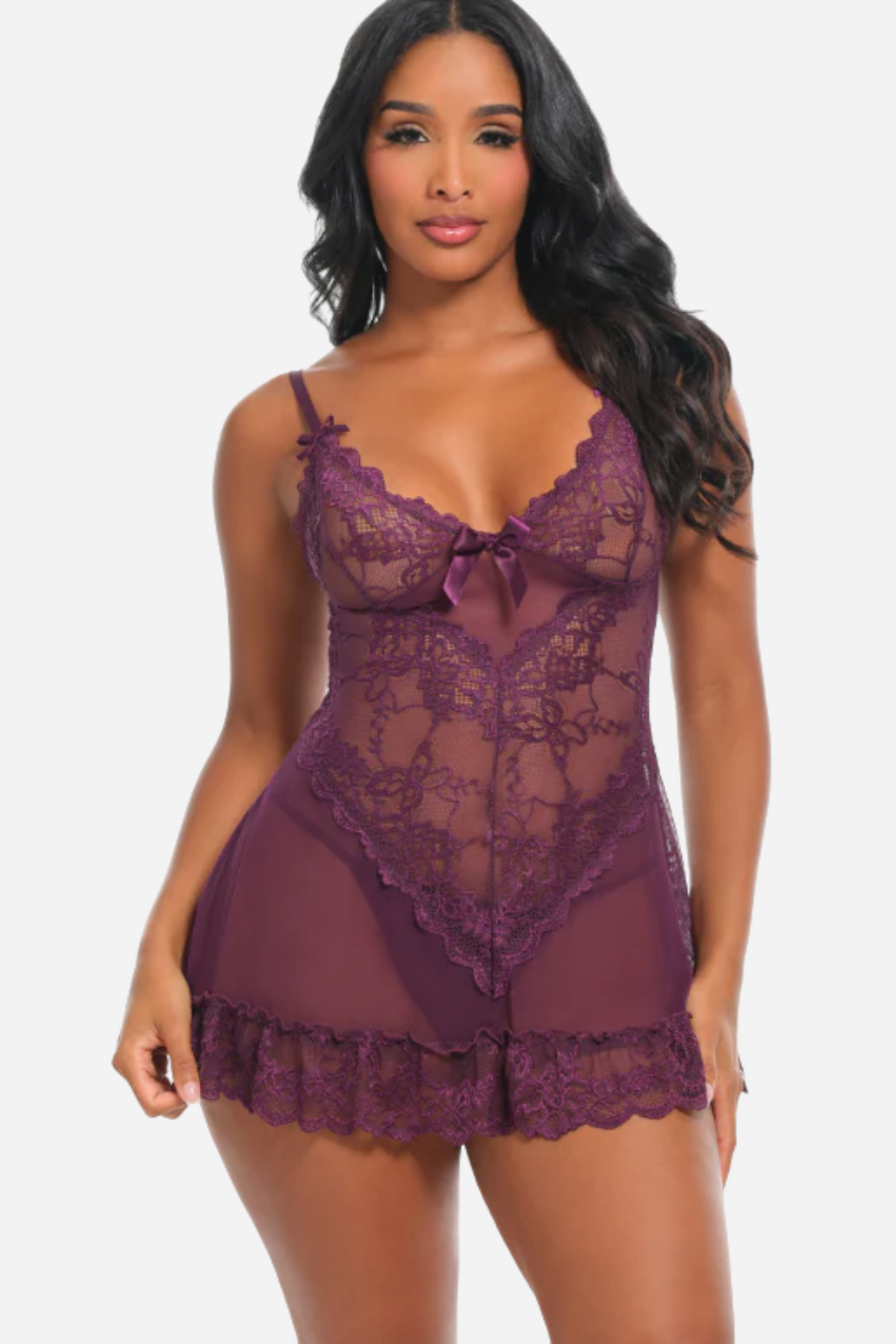 A model in the plum purple lace babydoll, floral lace cups sitting above a sheer flared skirt that ends in a scalloped lace hem.