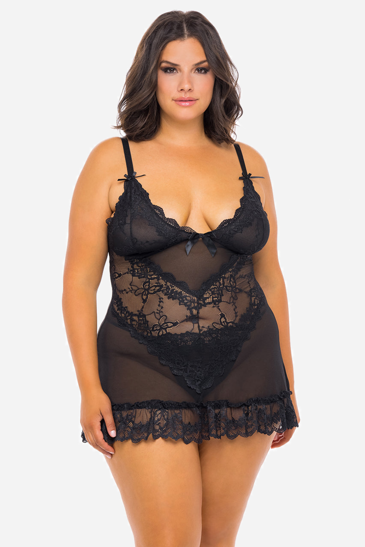 Front view of a black sheer babydoll on a curvy model, showing scalloped lace cups, a mesh body panel and a soft ruffled lace hem