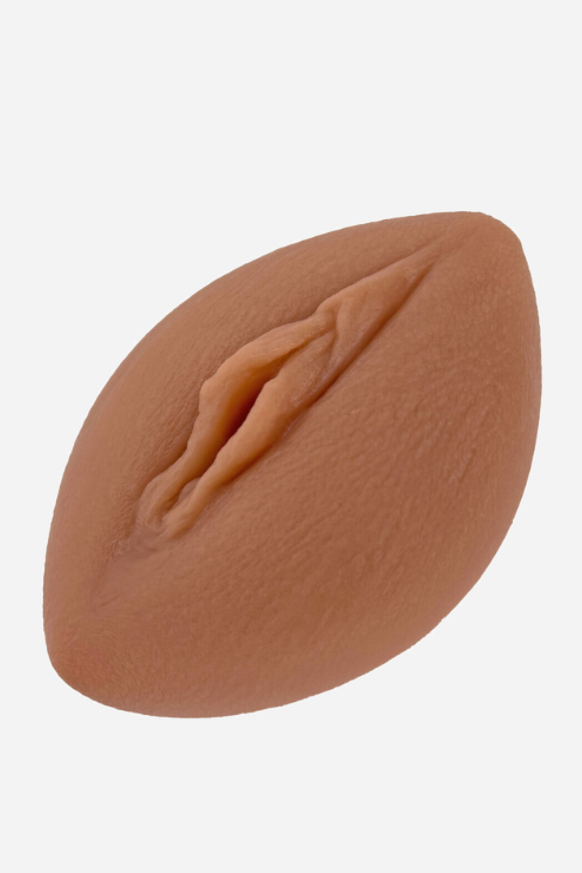 Tan Coochie stimulator cushion seen from above, a soft oval pad moulded with a vulva shape