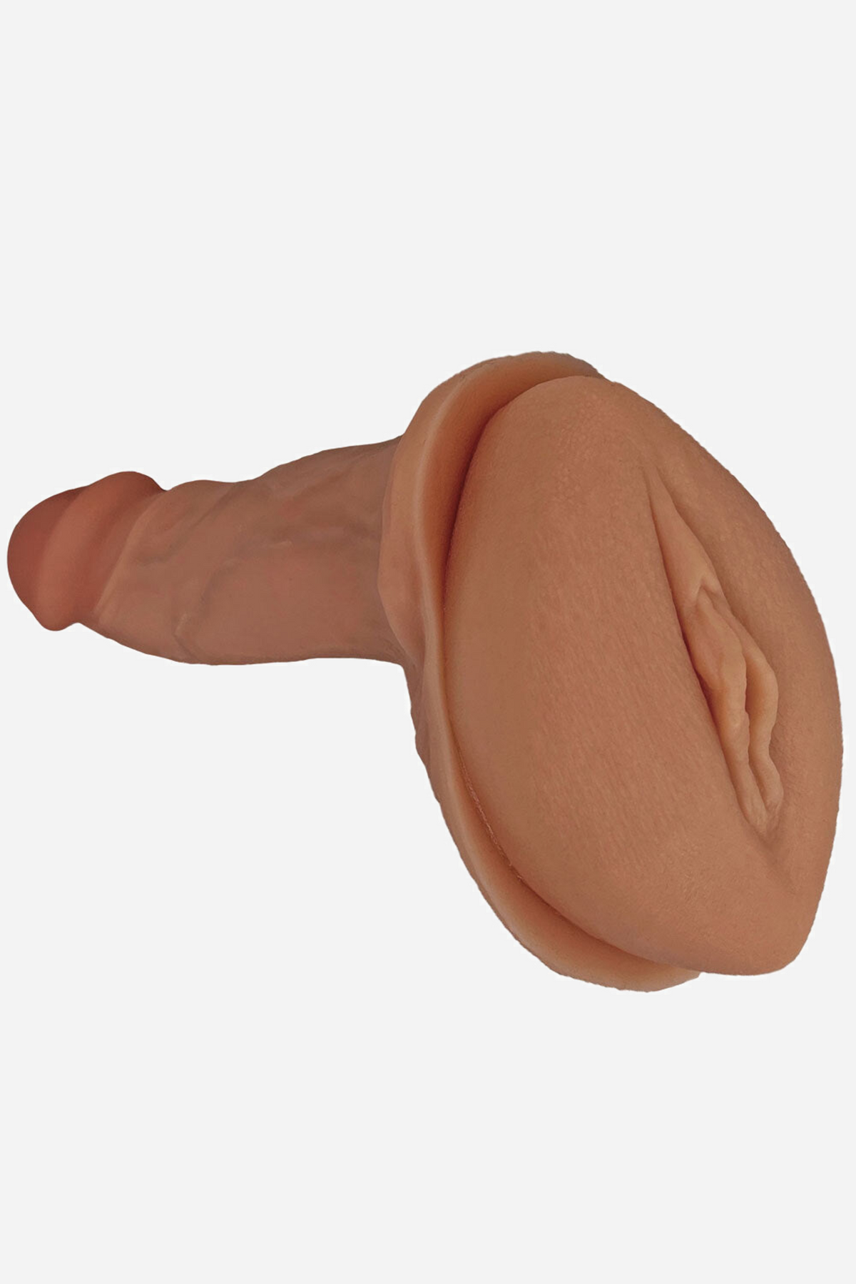 The tan cushion shown with a dildo mounted through its centre, seen at a three-quarter angle