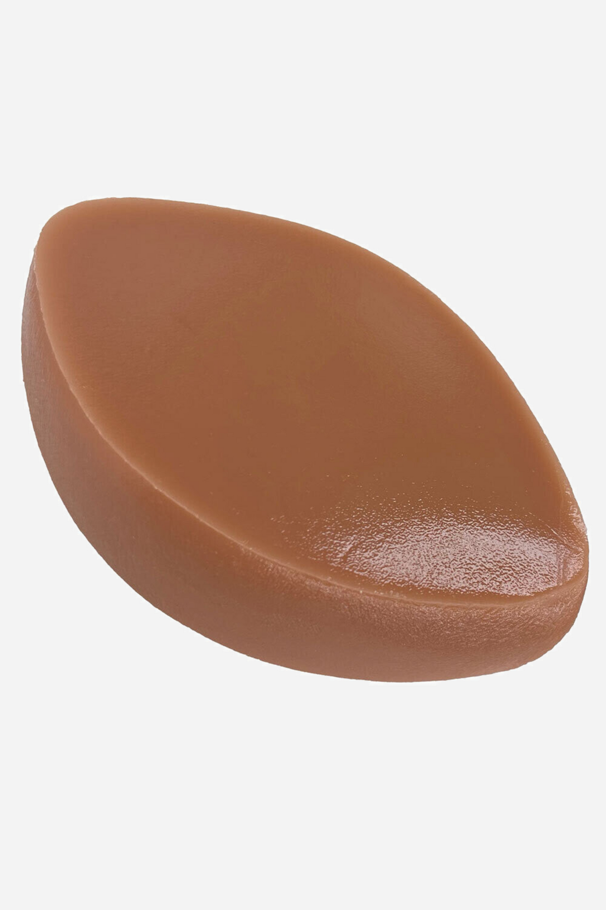 Toffee cushion seen from the side, showing its rounded teardrop profile and glossy underside