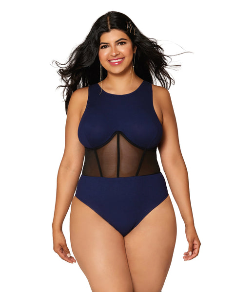 size extra large model smiles wearing the navy blue corseted teddy with mesh center panels