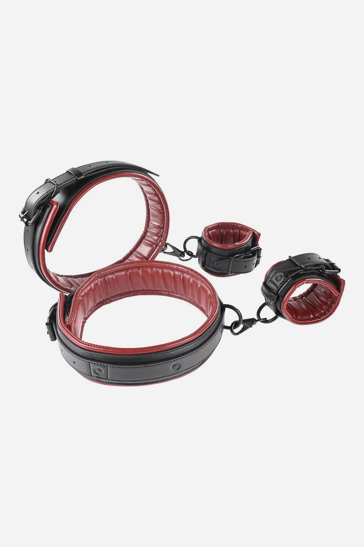 Crimson Spice vegan leather cuff set in black with red padded lining: two thigh cuffs and two wrist cuffs joined by black metal clips