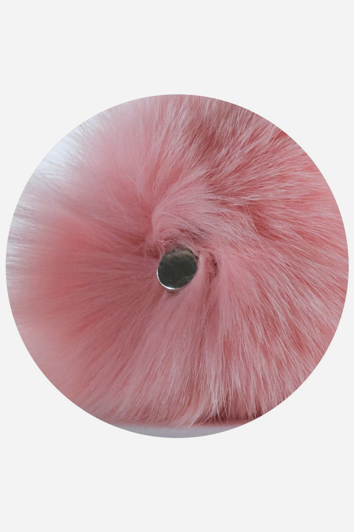 Round close-up on grey of the pink faux fur bunny tail from behind, a small silver magnet set in the centre where the tail clips onto the glass plug.