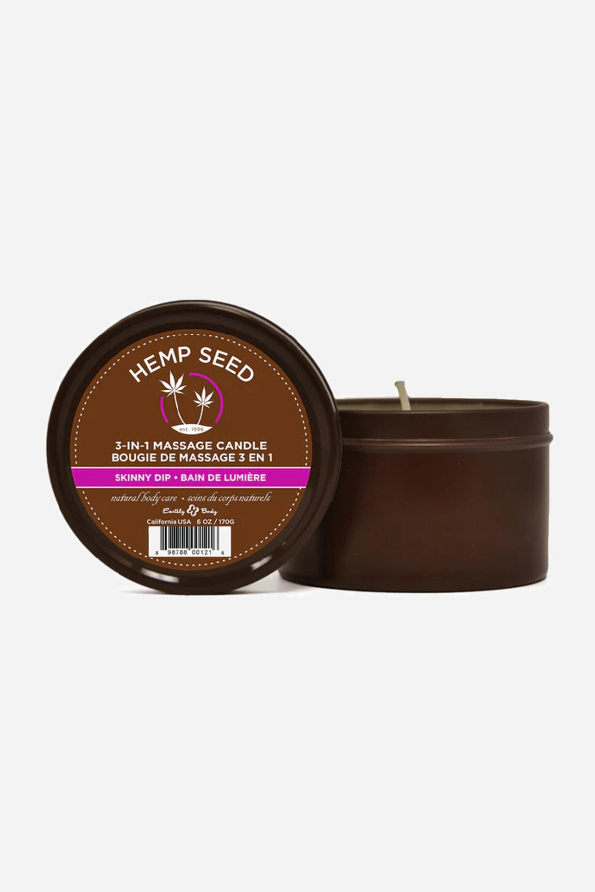 Two Hemp Seed massage candle tins, one propped up to show the Skinny Dip label and one open beside it with the wick standing up