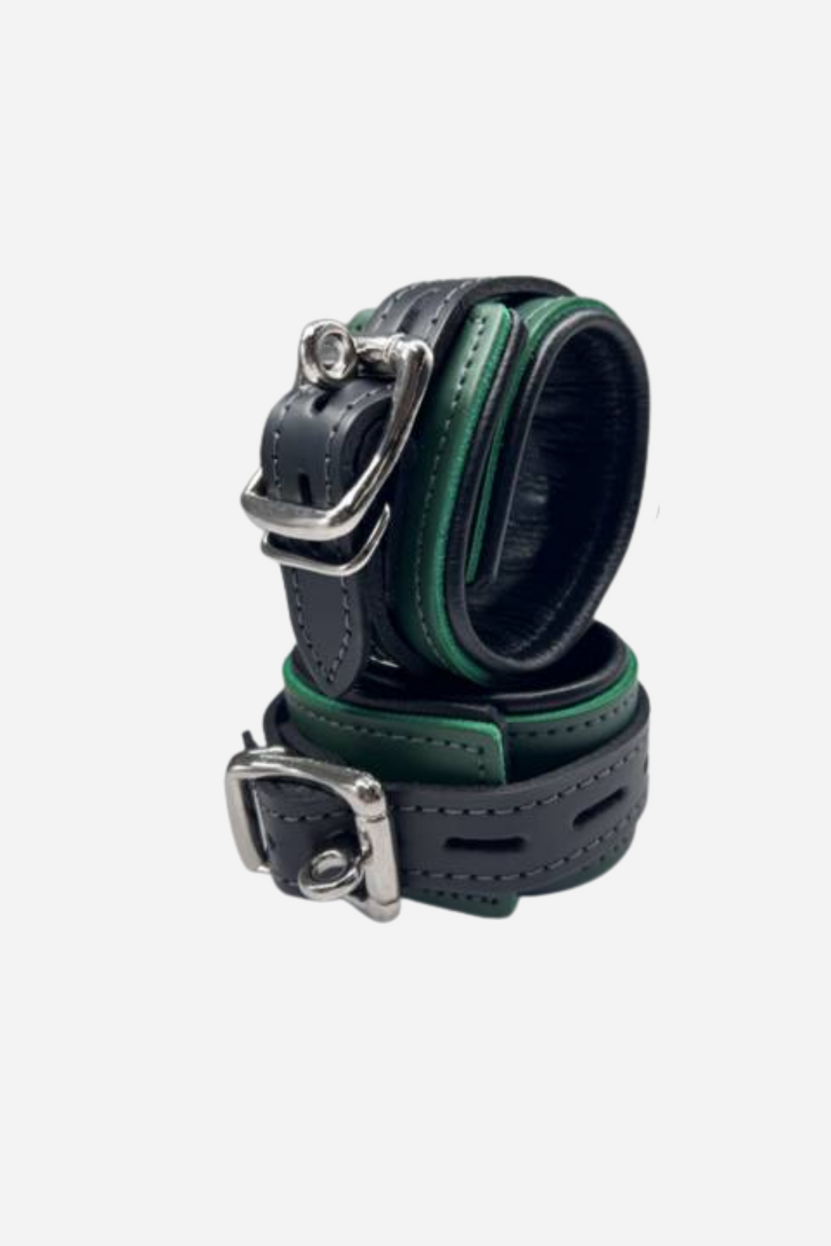 A pair of locking leather cuffs in black and green, the buckled straps stacked together with silver D rings and lock hardware.