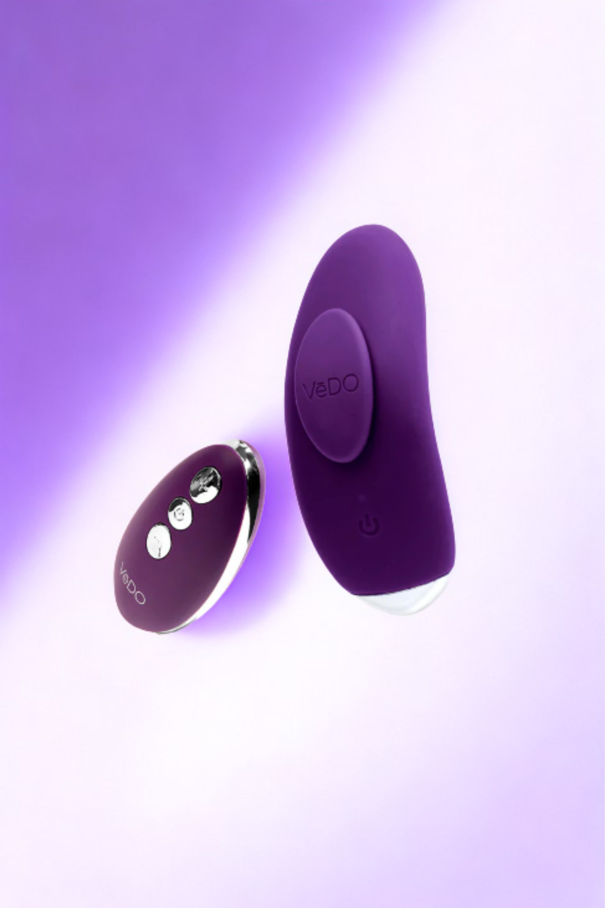 The purple Flexi Niki vibe and its remote lying together on a purple backdrop lit from one side, both catching a soft highlight.