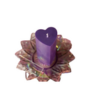 purple heart shaped wax play candle on a lotus dish