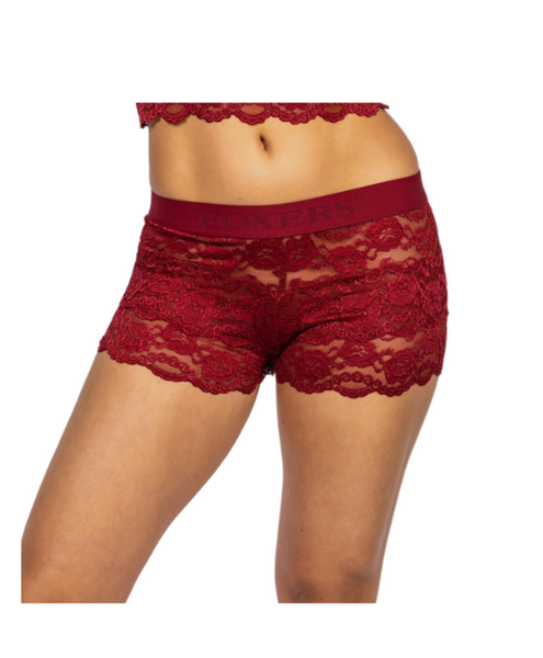 white female model in size small faces camera to show off the semi see through women's lace boxers in cherry