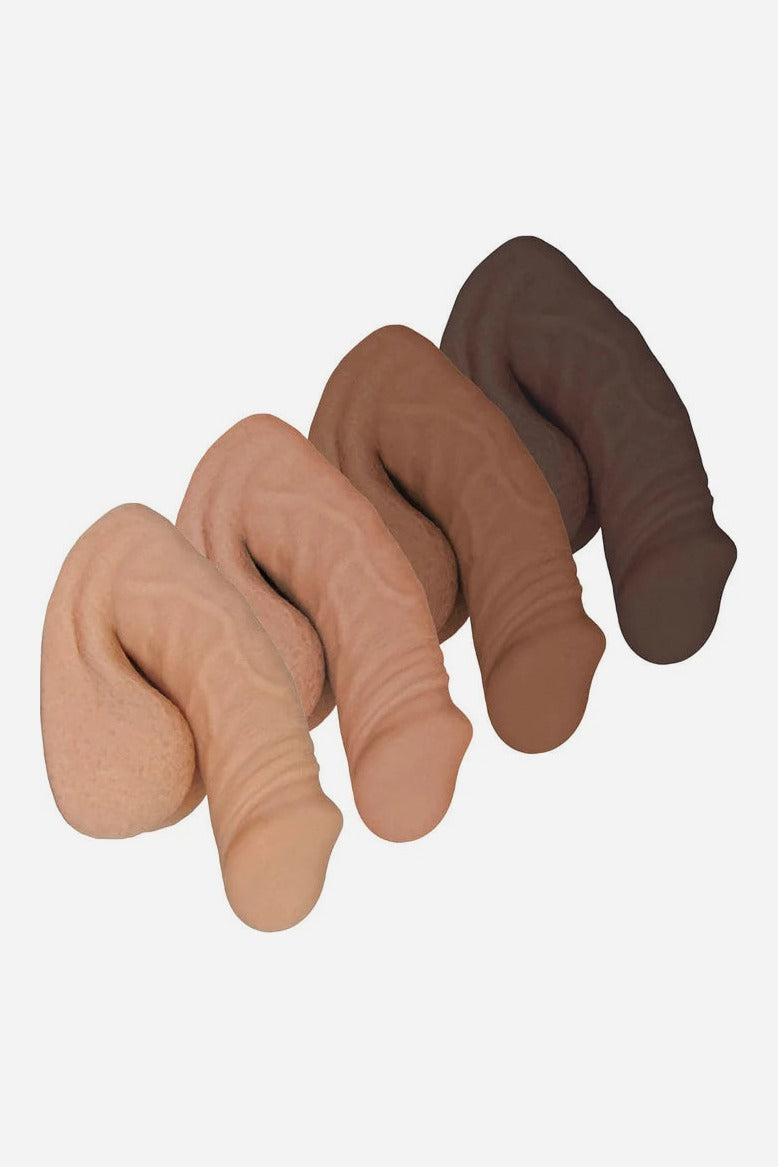 Four FreeForm 4 inch silicone packers lined up in vanilla, light caramel, caramel and chocolate skin tones, with realistic matte detail