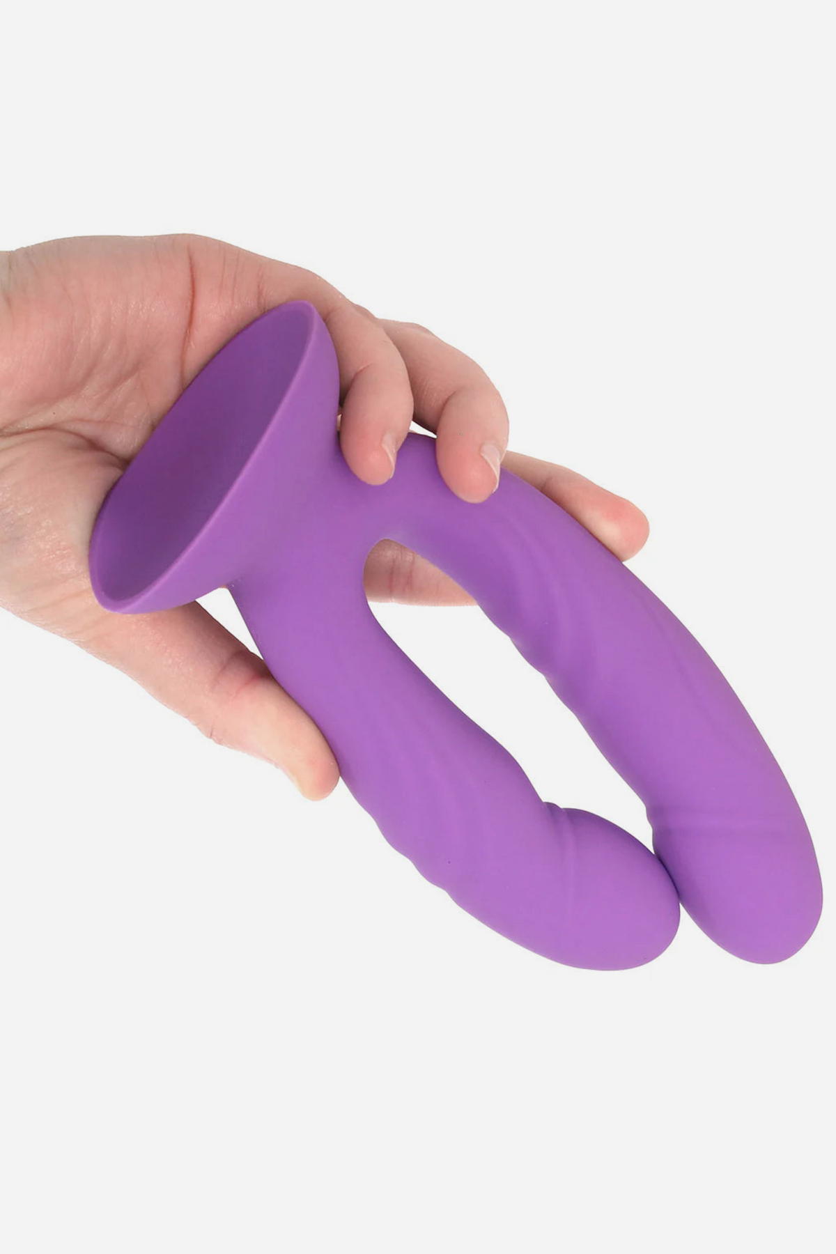 Two hands squeezing the shafts of the Get In Ya Dual Dildo together, showing they bend close enough to use in a single hole