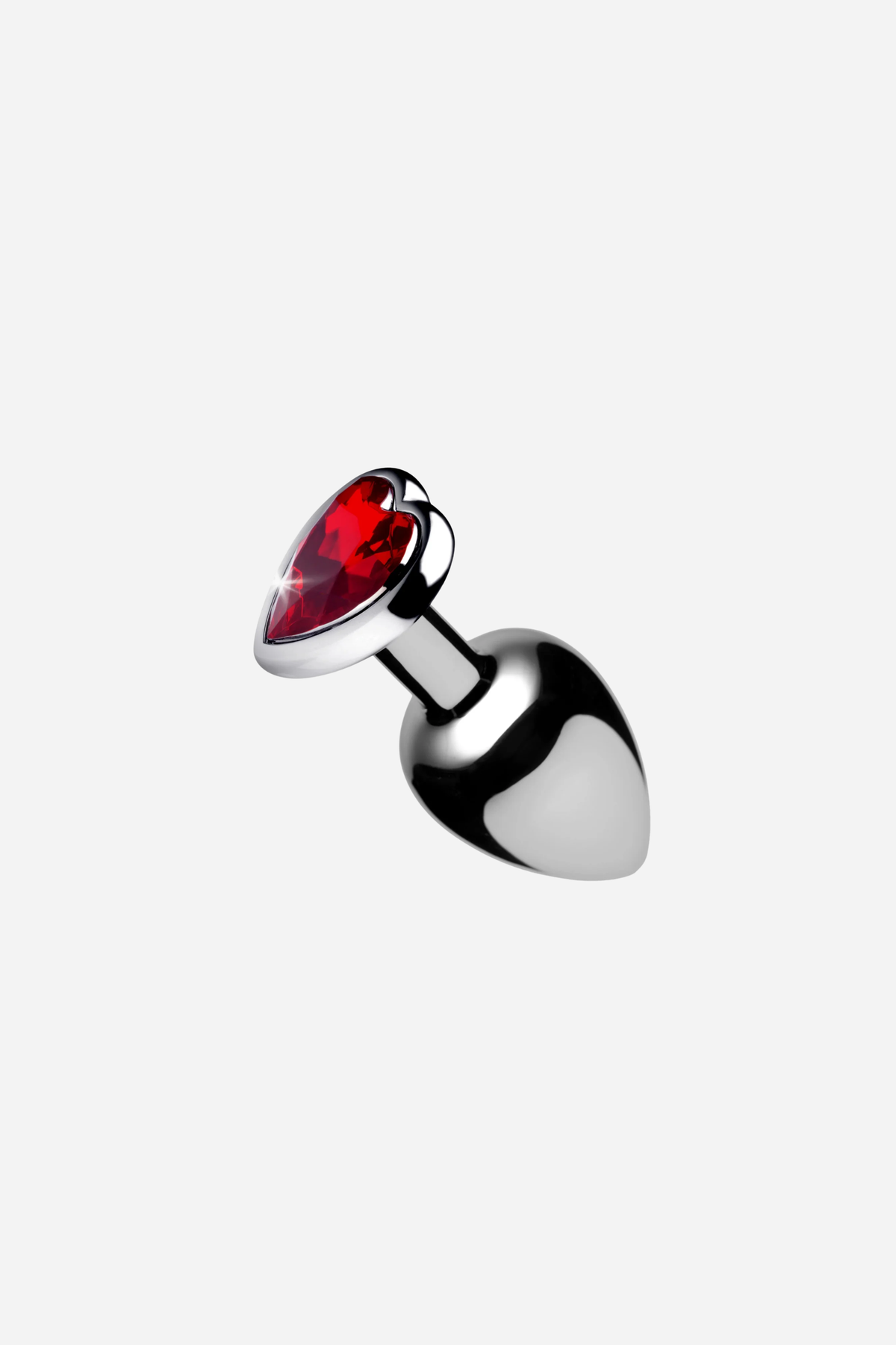 Heart Sparks Butt Plug in polished silver metal with a red heart-shaped gem base, shown at an angle on a light grey background