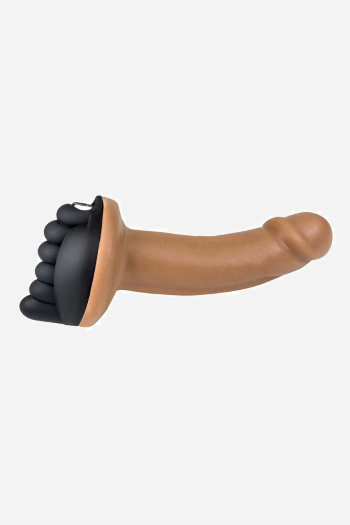 Side view of the black grinding pad at the base of a tan dildo, showing how low the nubbed pad sits against the wearer's body