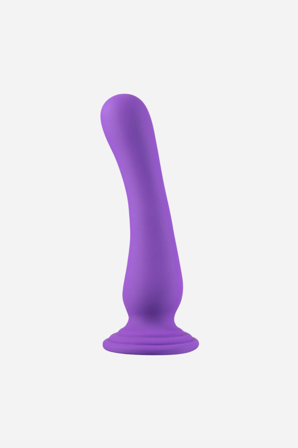 A purple silicone dildo standing upright on its round suction base, with a slim gently curved shaft and tapered tip, on a plain grey backdrop.