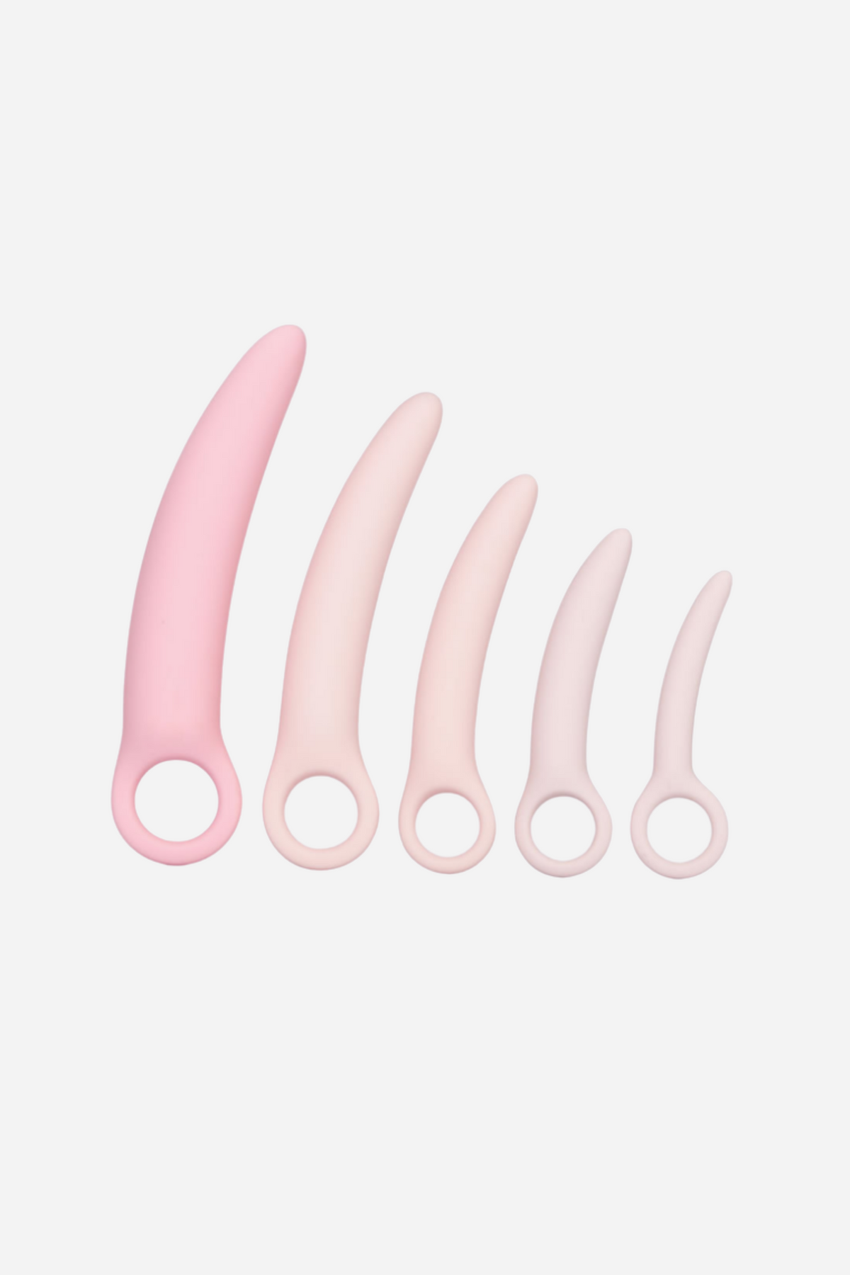 Five pale pink silicone dilators standing in a row, smallest to largest, each curved with a round finger loop at its base, against a grey backdrop.
