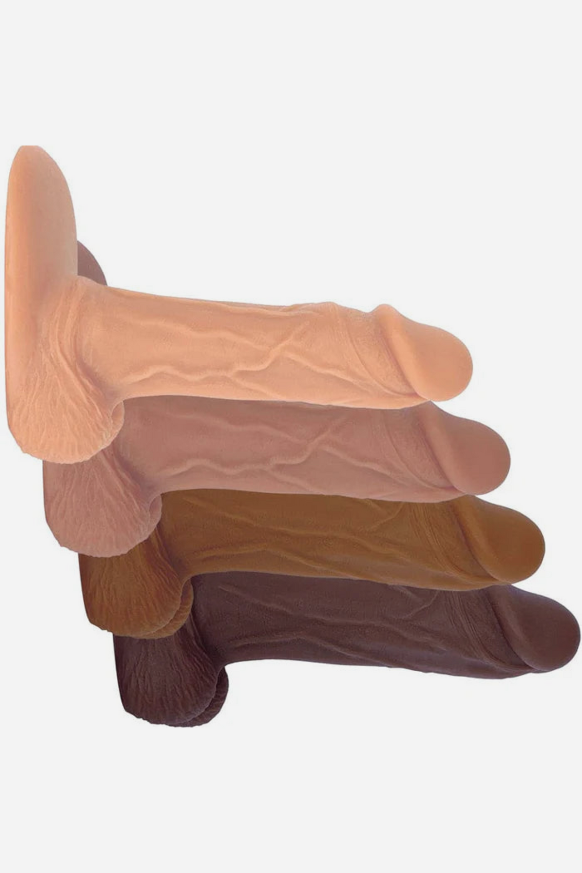 All four colours of the Jaxson realistic 7 inch silicone dildo stacked together in vanilla, light caramel, caramel and chocolate, on grey
