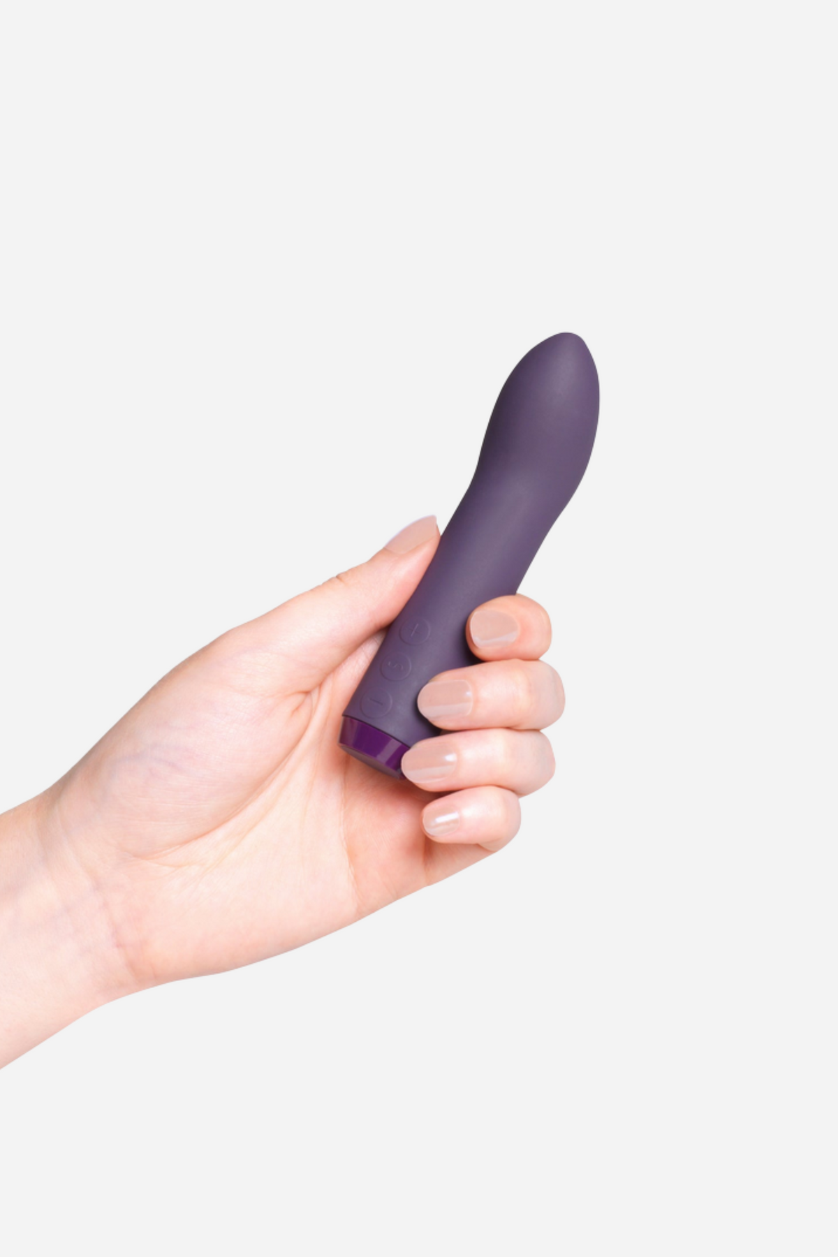 Je Joue G-spot bullet vibrator in Purple held in a hand, showing the slim body and curved G-spot tip, on a light grey background