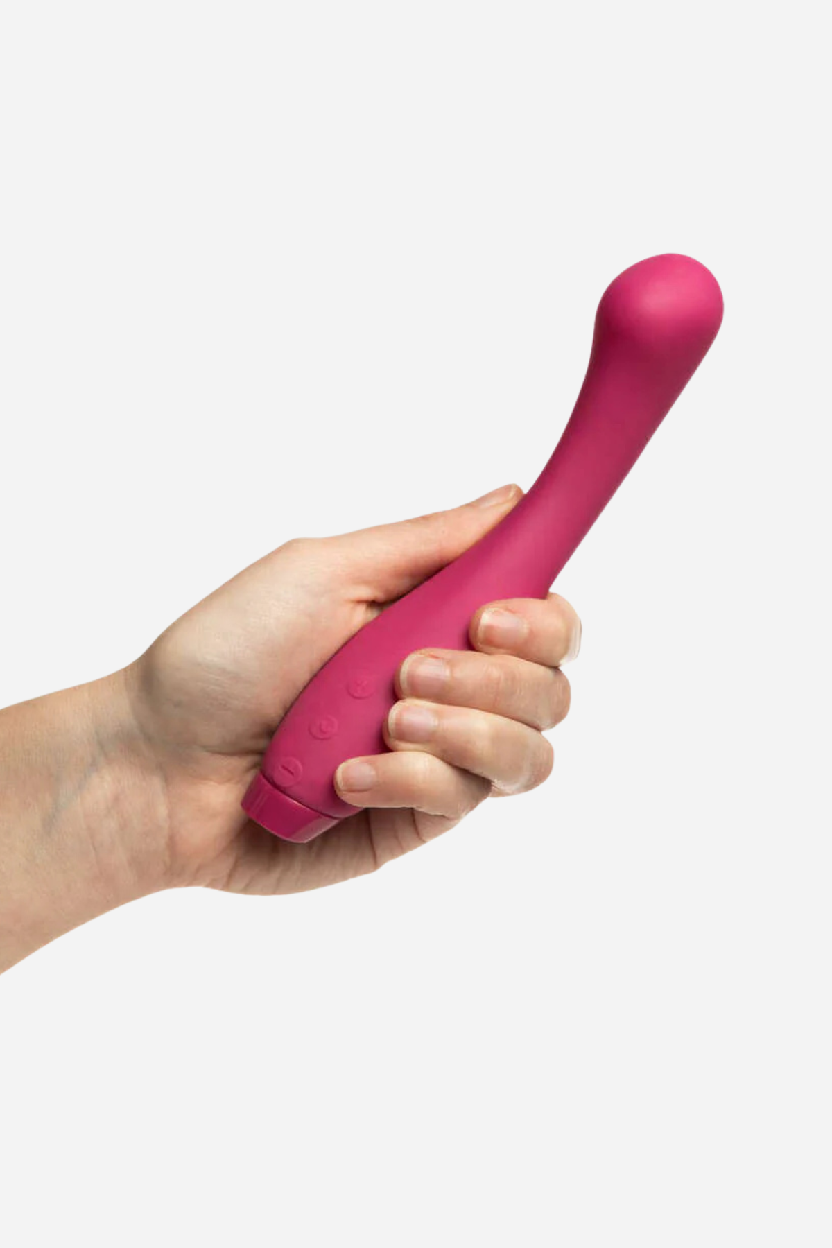 Hand holding the Je Joue Juno G-spot vibrator in Fuchsia, showing its size, curved neck and bulbous G-spot tip on light grey