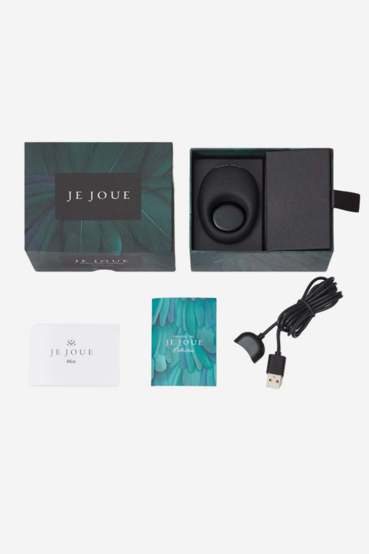 Flat lay of everything in the Je Joue Mio box on grey: the ring, its storage pouch, magnetic charging cable and printed instructions.