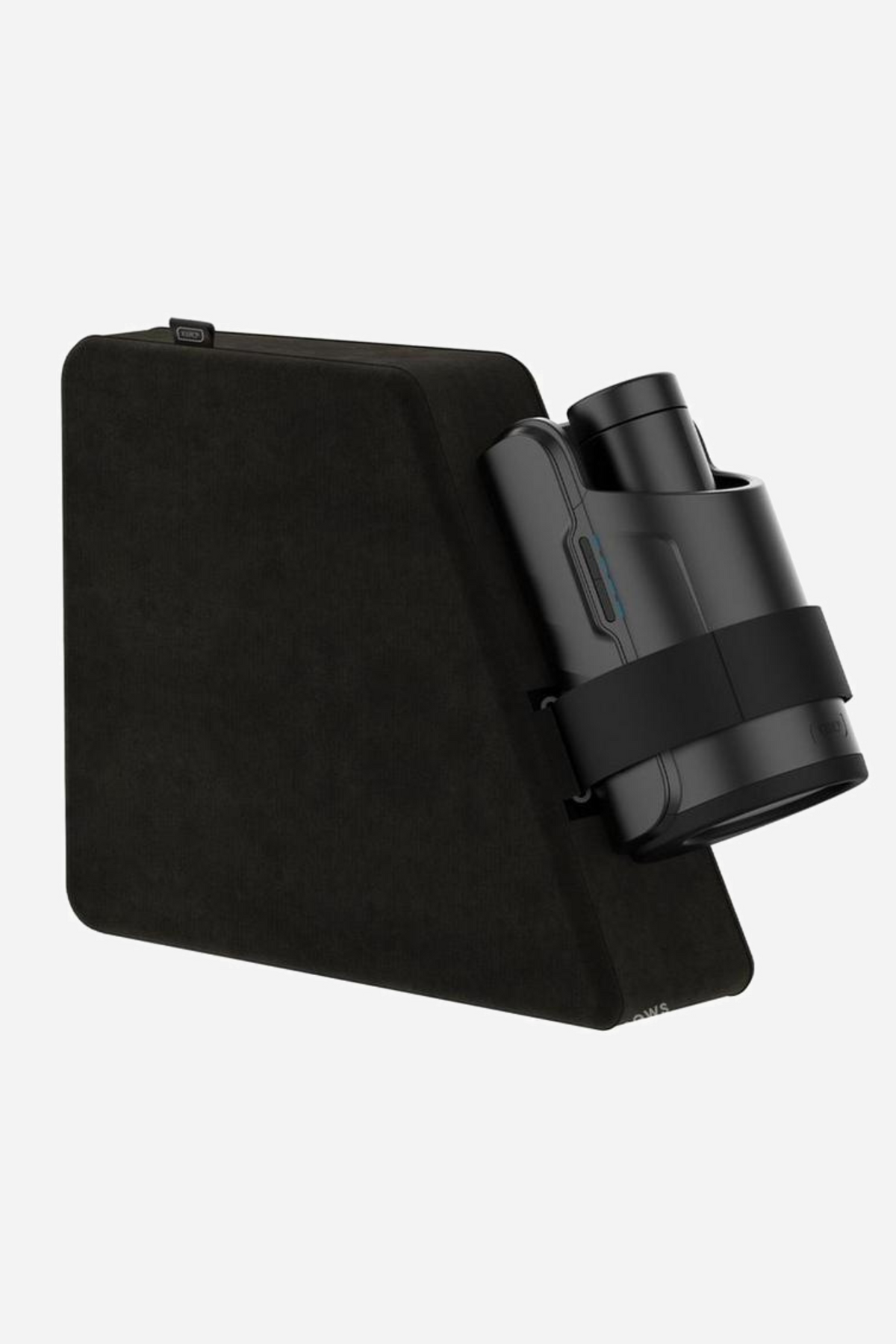 Black Kiiroo Keon pillow with the Keon stroker strapped to its angled face by the elastic band, positioned ready for hands-free use.